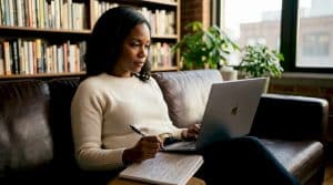 Woman comparing real estate options on laptop at home